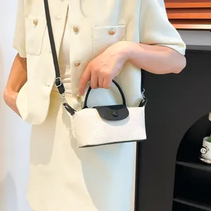 Contrast mini crossbody bag with embossed floral pattern and black top handle