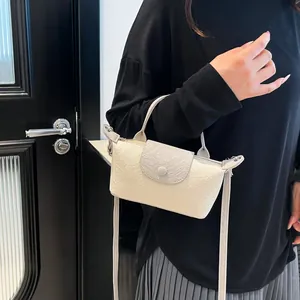 Mini faux-crocodile embossed crossbody bag in cream and grey contrast with top handles