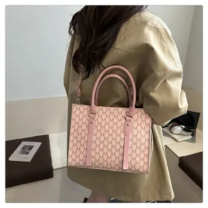 Classic pink mini square bag with M-letter pattern shown in a real-life styling scene