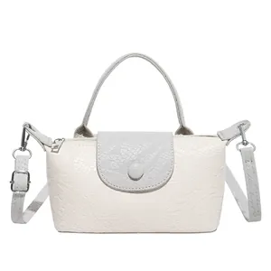 Minimalist beige crocodile embossed handbag with top handle and detachable crossbody strap