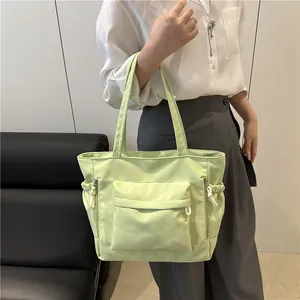 Light green large capacity tote bag with multi-pocket design for shoulder or hand carry