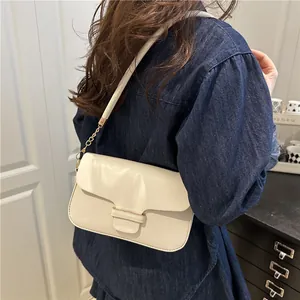 Minimalist ivory leather shoulder bag with gold metal clasp and chain strap detail