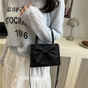 Sac à main chic noir pailleté avec nœud, poignée et bandoulière pour femme élégante