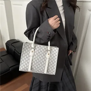 Classic white and grey monogram tote bag with top handles and gold hardware details