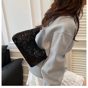 Detail of black sequined crescent hobo bag shown on model for elegant casual look