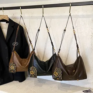 Classic hobo bags in brown, black, and coffee leather with leopard print B charms