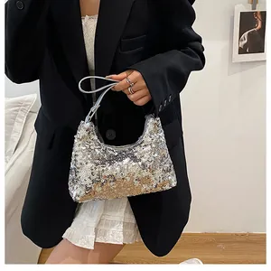 Close-up of shimmering silver and gold sequins on a trendy hobo crescent handbag