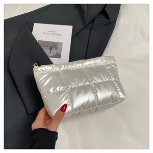 Détail de la trousse de maquillage argentée matelassée avec finition métallisée