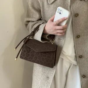 Vintage leopard print crossbody bag with gold hardware and brown matte texture