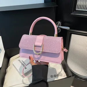Pink crossbody handbag for women featuring a glitter top flap and gold D-ring buckle
