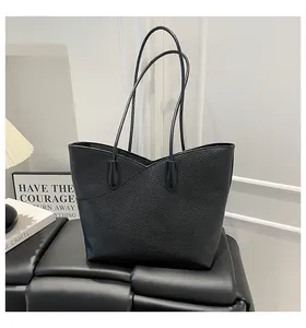 Close-up of premium black lychee grain leather tote bag with V-shaped edge detail