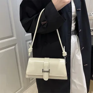 Chic cream white faux leather shoulder bag with decorative knots and silver clasp detail