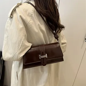 Glossy dark brown leather shoulder bag with silver square buckle for elegant autumn fashion