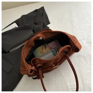 Top view of brown suede tote bag showing large capacity and internal magnetic closure