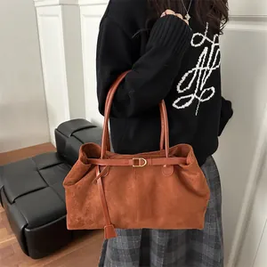 Caramel brown suede shoulder bag with golden D-ring buckle and elegant top handle