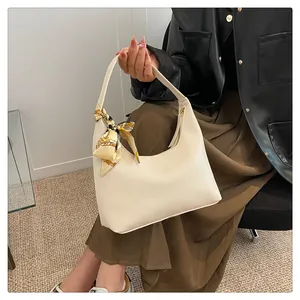 Close-up of off-white lychee texture tote bag with printed silk scarf detail