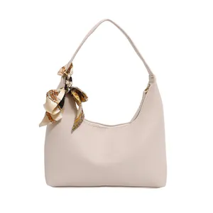 Chic beige crescent hobo handbag with pebble texture and decorative printed silk scarf