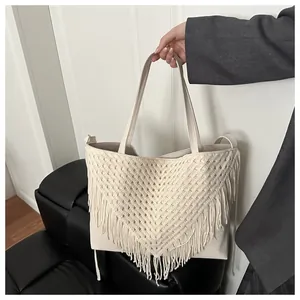 Detail of cream-white tassel tote bag with crochet V-pattern and faux leather texture