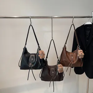Three minimalist faux leather tote bags in black, dark brown, and brown with bear charms