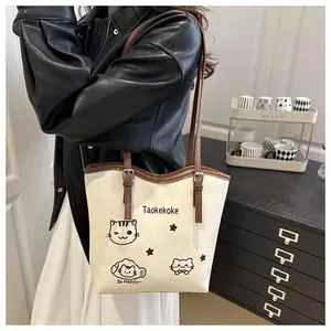 Detail of the high-quality tote bag featuring cat print and brown shoulder straps
