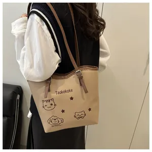 Detail of beige bucket bag with cat print, brown strap and adjustable buckle