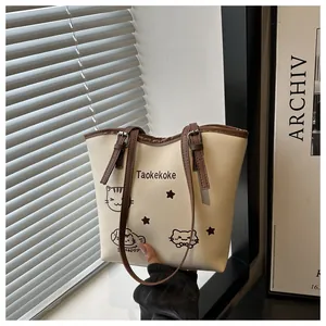Detailed view of women bucket bag with cat print, leather trim and adjustable strap