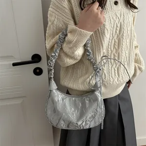 Silver pleated crescent bag with bow decoration and metallic glossy finish for women