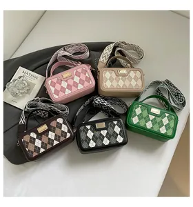 Detailed arrangement of five Argyle plaid crossbody bags with gold buckles and straps