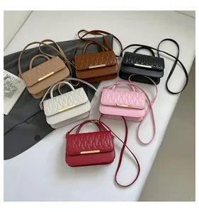 Close-up of small crossbody bags in six colors with quilted waves and gold hardware