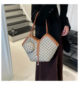 Detail of checkered bucket bag with mini pouch showing leather trim and shoulder strap