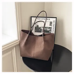 Détail du grand sac cabas en daim marron foncé avec de fines bandoulières