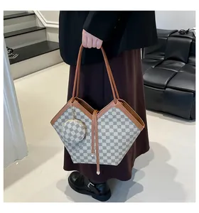 Detail of checkered bucket bag with leather trim and matching round coin purse pouch