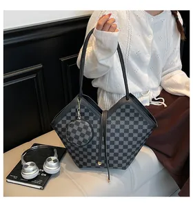 Detail of checkered tote bag and matching round coin purse shown in a lifestyle setting
