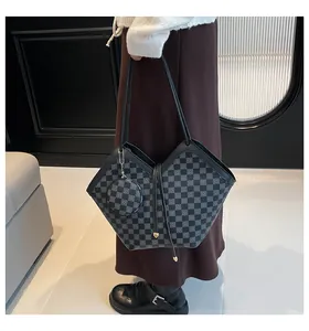 Detailed macro view of the checkered pattern tote bag with matching round coin purse charm