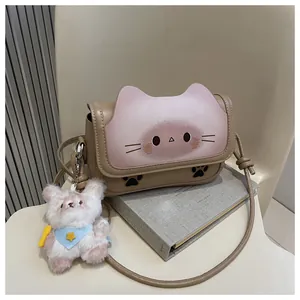 Détail du rabat en forme de tête de chat sur sac à main marron avec ours en peluche