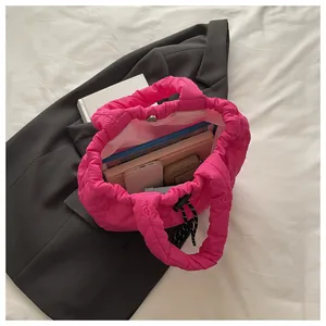 Top view of pink quilted bucket bag showing large capacity for books and phone