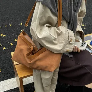 Detailed macro view of retro brown frosted tote bag with adjustable leather shoulder straps