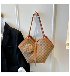 Detail of checkered brown tote bag with matching coin purse and leather strap on a hook