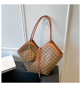 Detail of checkered bucket bag with V-cut top and matching round coin purse charm