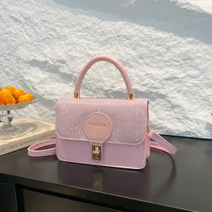 Elegant pink mini square bag with glitter flap and gold lock for stylish women