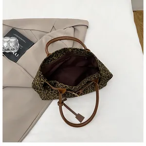Top view of leopard print tote bag interior showing spacious storage and leather handles
