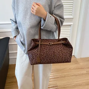 Fashionable leopard print tote bag with brown leather handles and gold buckle for women