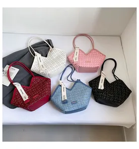 Detail view showing five colors of tweed bucket bags with decorative logo ribbons