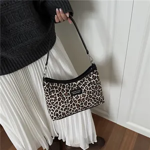 Trendy leopard print shoulder bag with black leather strap for autumn and winter outfits