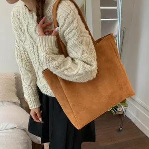 Minimalist large capacity tan suede tote bag styled with casual winter knitwear outfit