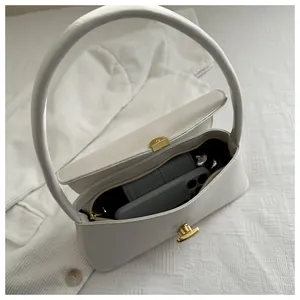 Detail showing the internal storage capacity and round handle of the white square handbag