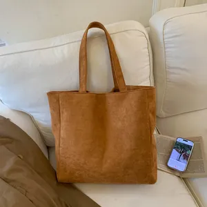 Detailed texture of warm brown corduroy tote bag showing its large capacity and soft fabric