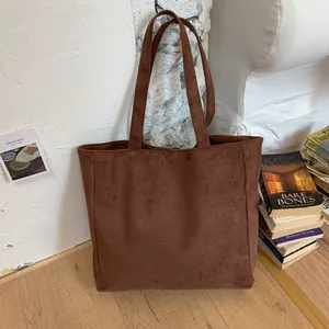 Brown suede tote bag with spacious rectangular design and minimalist retro style