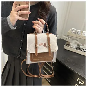 Lifestyle shot of vintage cream canvas backpack with cat motif and brown leather trim