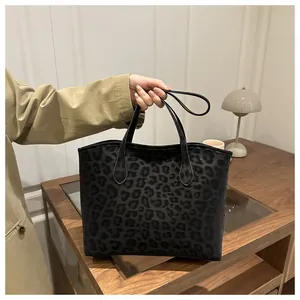 Close-up of a leopard print tote bag with flat handles in a cozy minimalist home setting